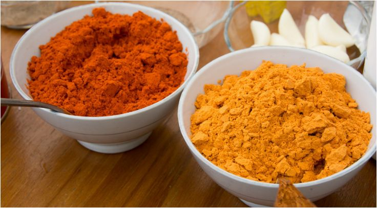 Two bowls of red and golden shiro powder